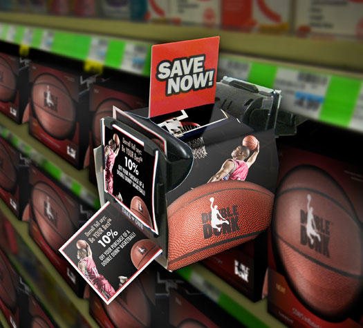 Image of a coupon dispenser attached to the side of a shelf containing Double Dunk basketballs. The dispenser has a picture of basketball player Darrell Yell on it and the words, 'Be your best.' Sticking out of the dispenser is a coupon advertising 10% off the price of a Double Dunk basketball.