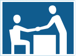 two people shaking hands over a desk